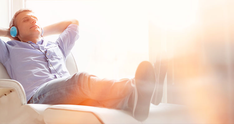 Man lying back on comfortable recliner
