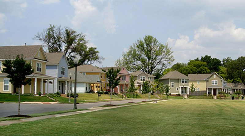 Illustration of a residential neighborhood with houses under a partly cloudy sky to support real estate housing market crash article