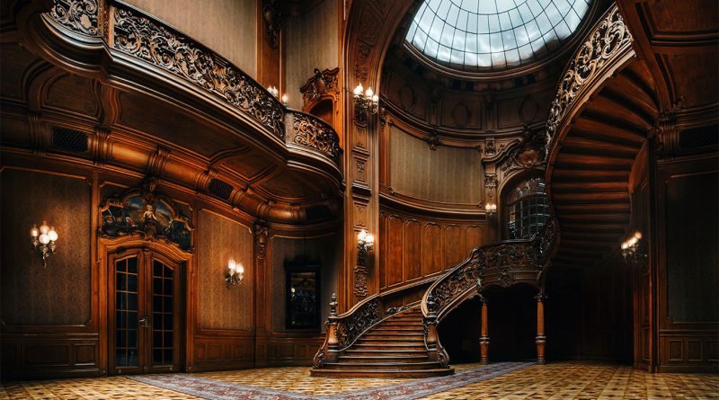 Image of a very large and luxurious wooden staircase in a big open plan room to support mansion article