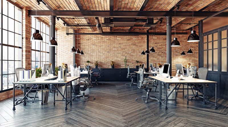 Image of a large, open plan empty office with wooden walls and desks to support US housing shortage article