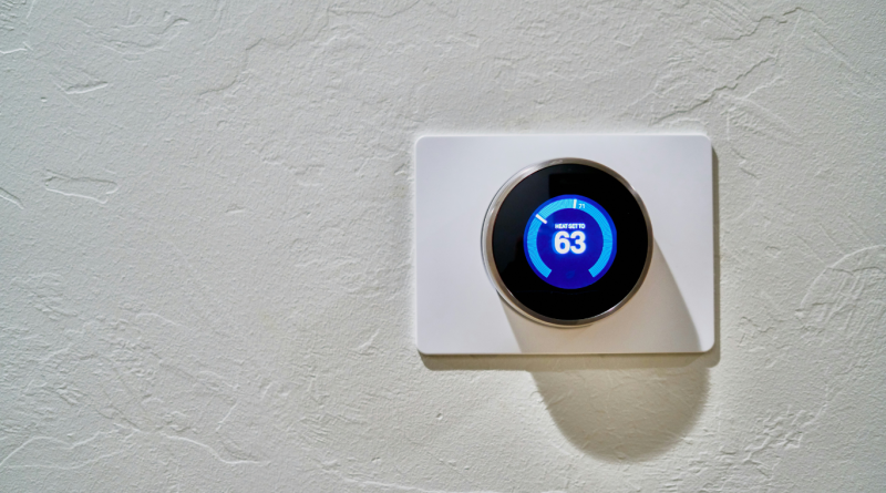 Smart thermostat set to 63 degrees, showcasing energy-efficient home technology.