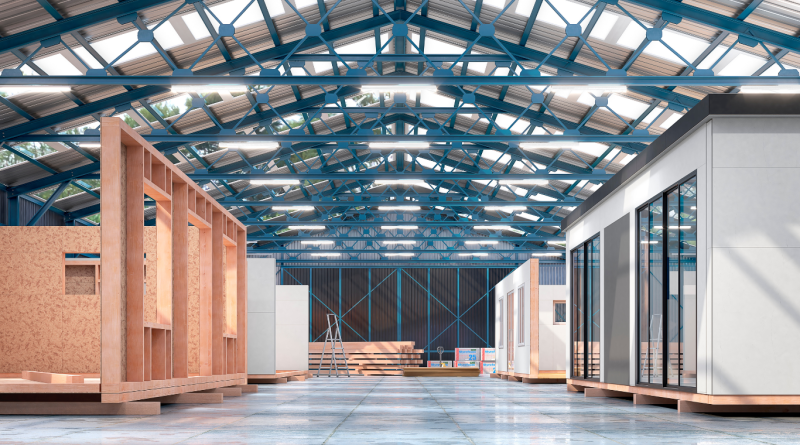 Interior of a factory constructing manufactured housing units, showcasing the efficient and cost-effective prefabrication process.
