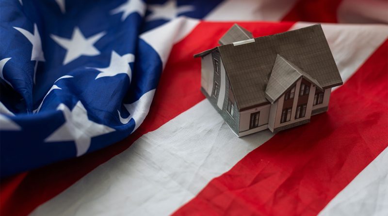 Trump at signed pedestal behind American flag to support Trump housing policies article