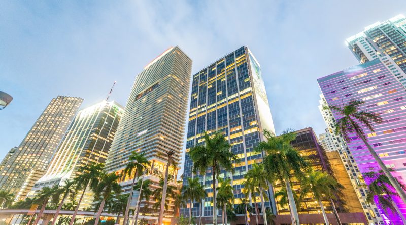 Aerial view of luxury high-rise condominiums along the Miami coastline at sunset