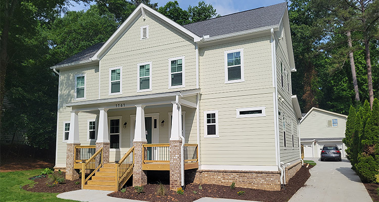 two-story single-family home with a prominent covered front porch