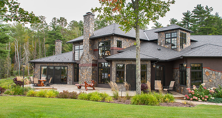 a large, custom-built residential house, specifically identified as "Aqua Terra" by Andersen