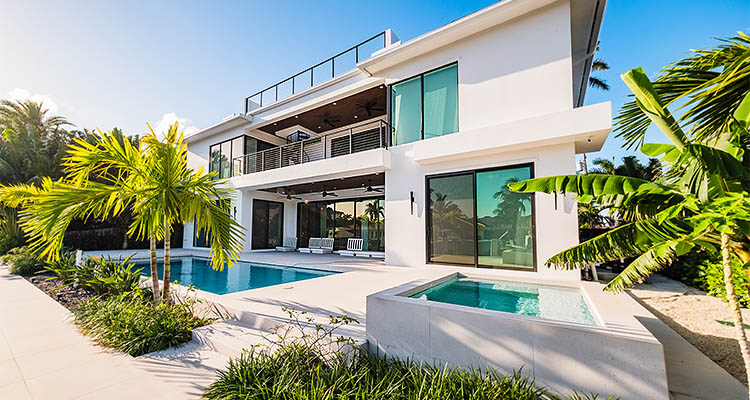 a modern luxury home with a swimming pool and spa
