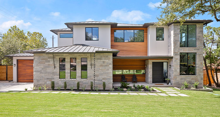 a modern, two-story house with a distinctive architectural style, likely a contemporary or modern farmhouse design
