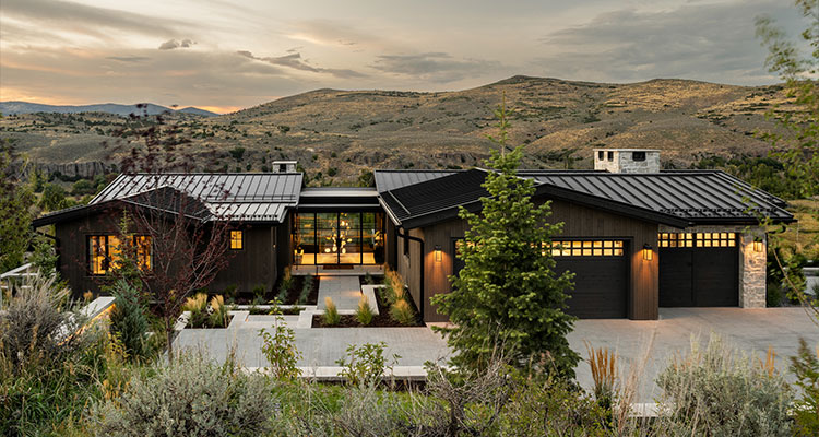 a modern ranch-style home in a natural, mountainous setting