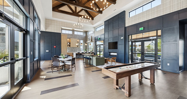 a spacious and modern common area or clubhouse, specifically identified as part of The Crest at Oakwood Apartments