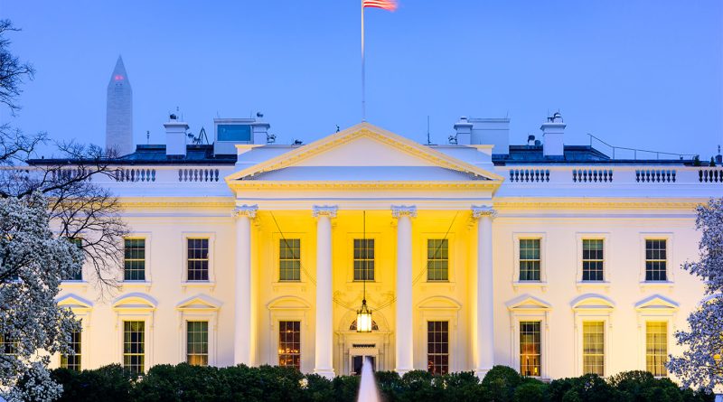 The White House in Washington, D.C., framed against a clear sky, symbolizing decades of renovations and preservation.