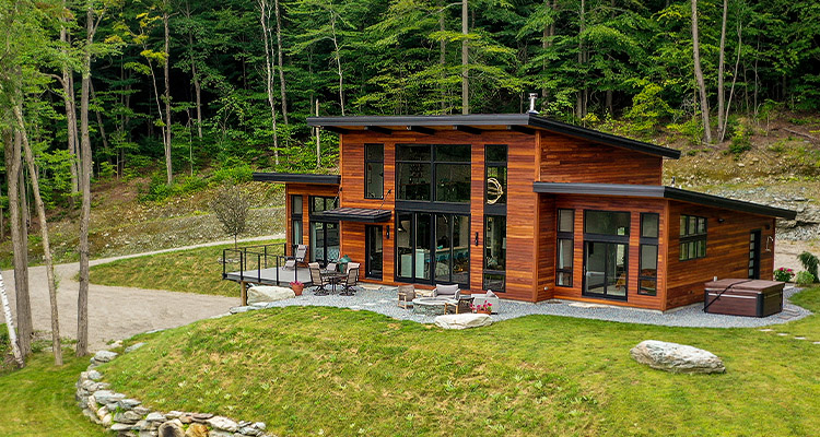 a modern post and beam house known as the "Hill House" by Yankee Barn Homes.