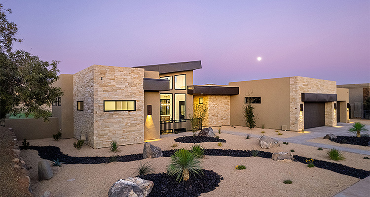 a modern, single-story residence with a combination of light-colored stone, stucco, and a flat roofline