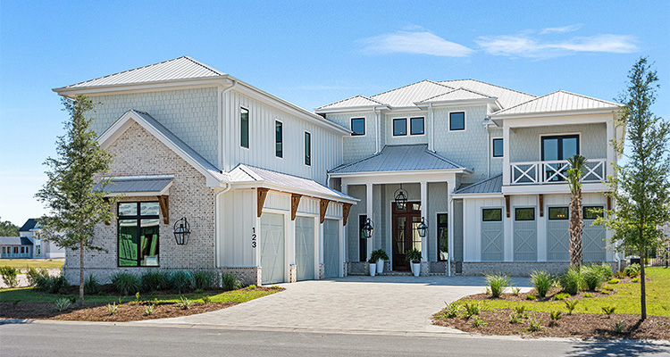 a large, modern-style house with a light-colored exterior