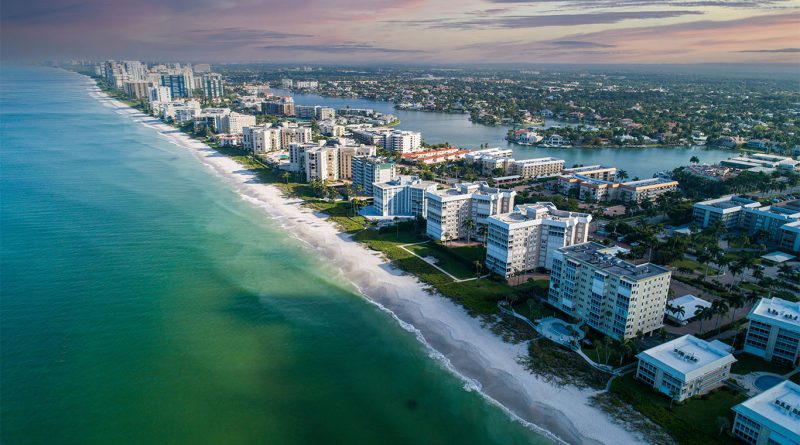 Luxury waterfront home in Naples Florida with for sale sign in 2025