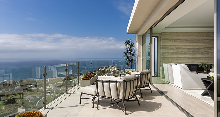 a luxurious outdoor patio area with a modern design and a breathtaking ocean view