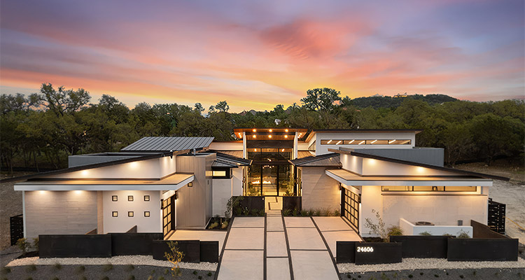 This house exhibits a striking contemporary or modern architectural style, characterized by clean lines, a single-story design with varied rooflines