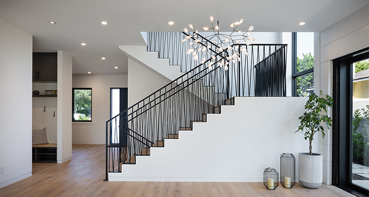 a contemporary residential interior showcasing a custom metal staircase.
