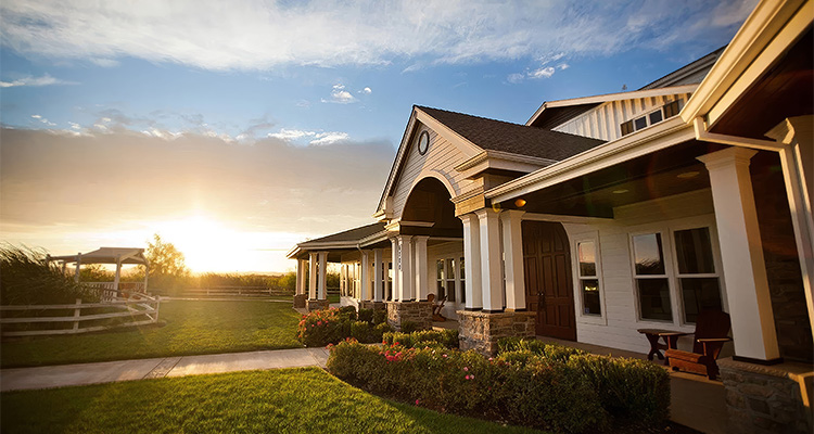 the exterior of the Hannah Nicole Vineyards building at sunse