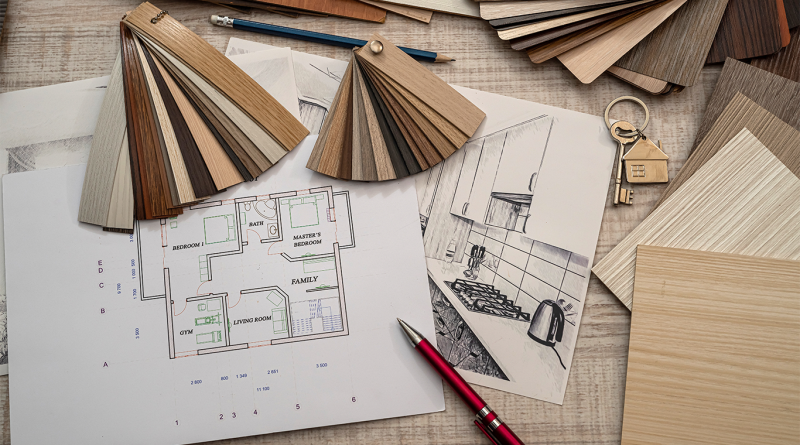 Assorted wood finish samples, architectural plans, and interior sketches arranged on a designer’s desk for luxury home planning