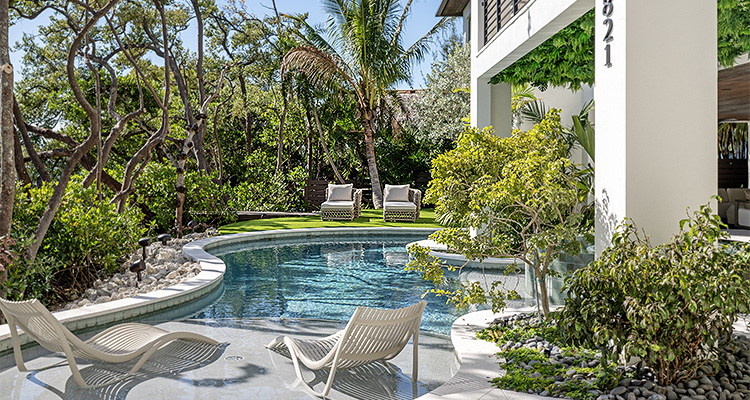 the outdoor pool and lounge area of a luxury vacation rental home