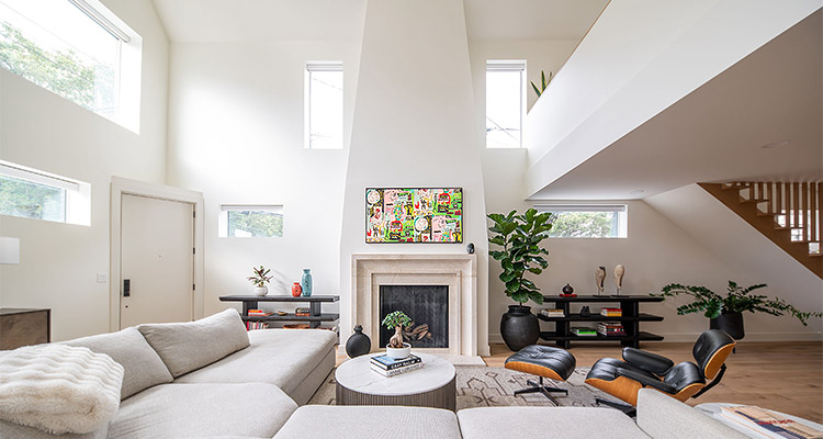 a modern living room featuring a fireplace with a Colemandia marble surround.