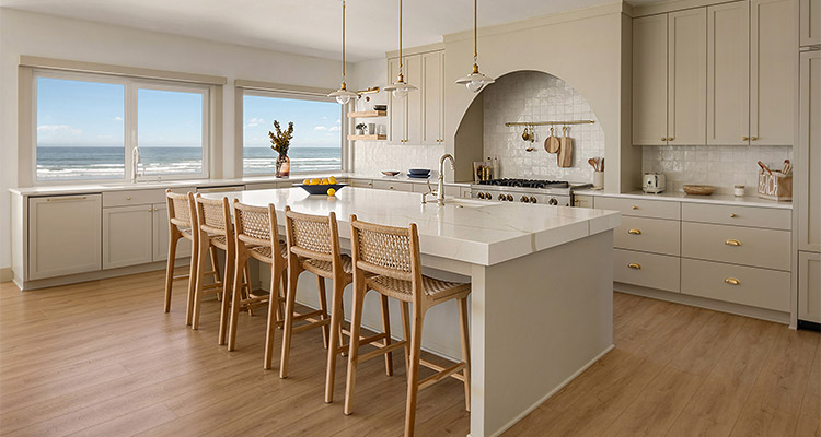 a modern, light-filled kitchen with a large island and an ocean view
