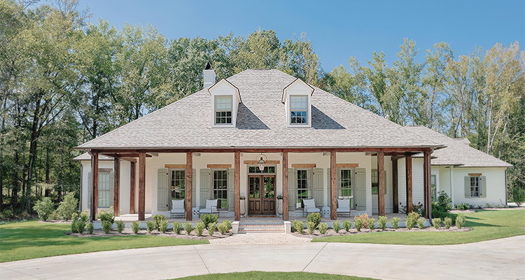 Louisiana-style house featuring rustic beam work and old brick accents